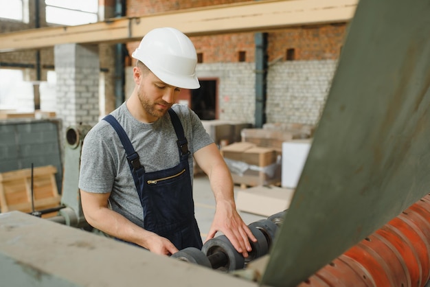 Worker in factory on the machine