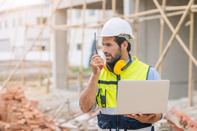 Worker foreman engineer builder working using radio command in home construction site safety check