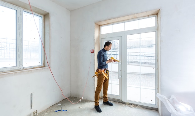 Worker in glazier's workshop, warehouse or storage handling glass