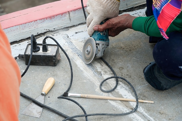 Worker grind hard floor Worker with high shear grinder cut