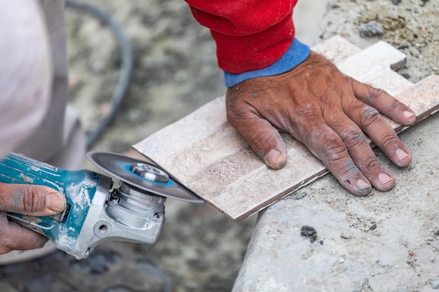 Worker Grinding Corner Tile for Fitting