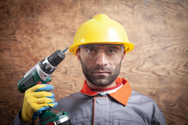 Worker holding cordless screwdriver Construction tool