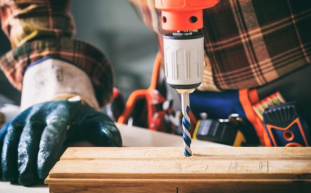 Worker holding an electric drill