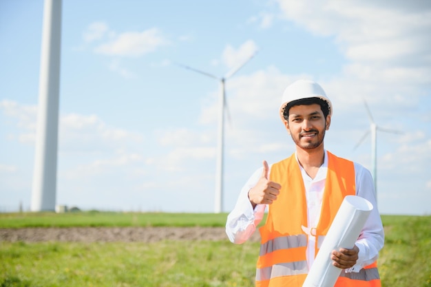 Работник в сфере устойчивой энергетики Инженер, работающий на альтернативной возобновляемой ветряной электростанции