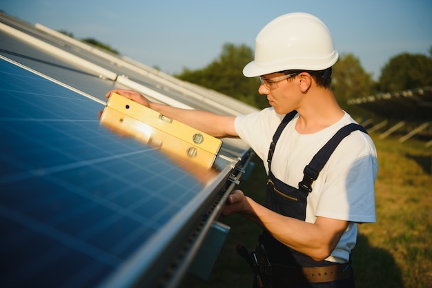 Worker installing solar panels outdoors