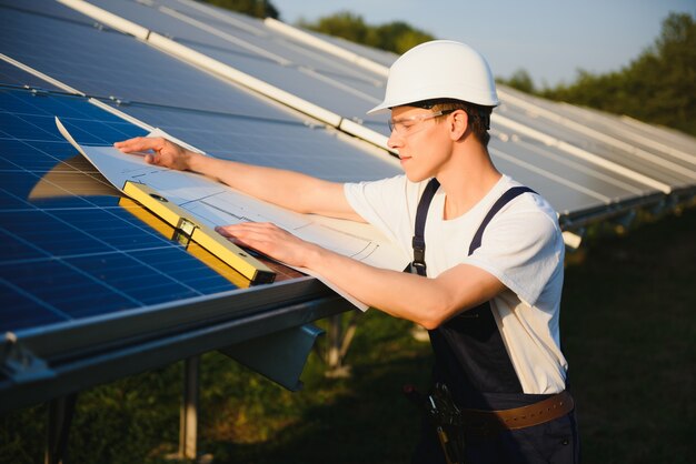 Worker installing solar panels outdoors