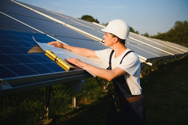 Worker installing solar panels outdoors