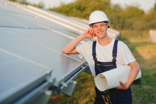 Worker installing solar panels outdoors