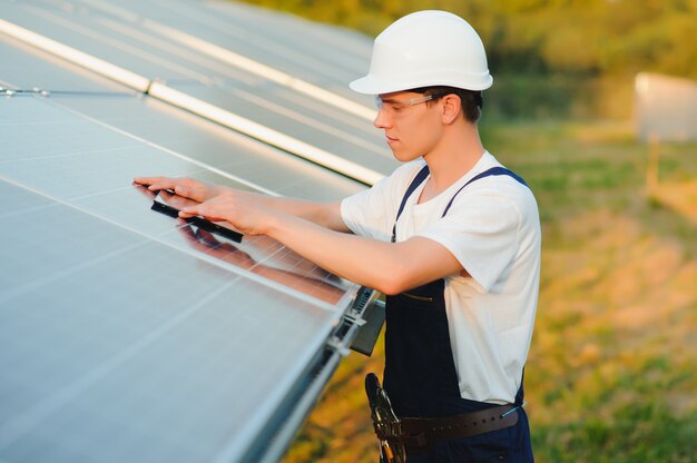 Worker installing solar panels outdoors