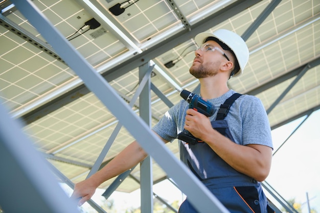 Worker installing solar panels outdoors