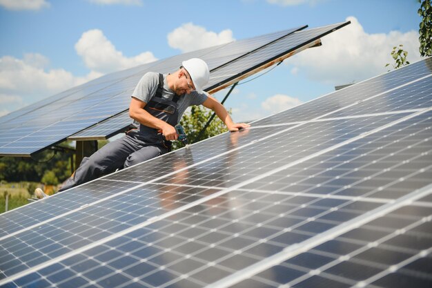 Worker installing solar panels outdoors