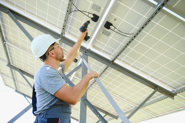 Worker installing solar panels outdoors