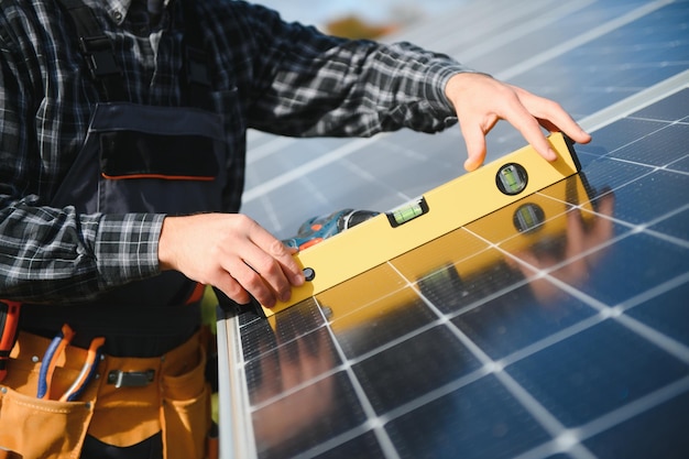 Worker installing solar panels outdoors