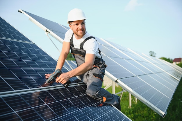 Worker installing solar panels outdoors