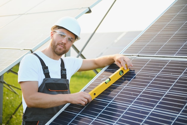 Worker installing solar panels outdoors