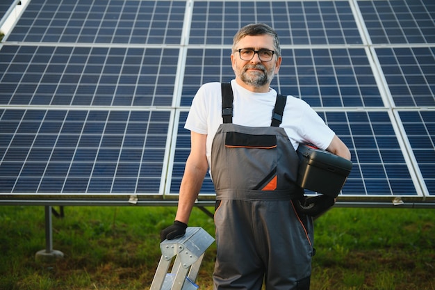 Worker installing solar panels outdoors