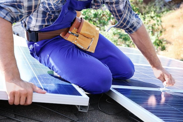 Worker installing solar panels outdoors