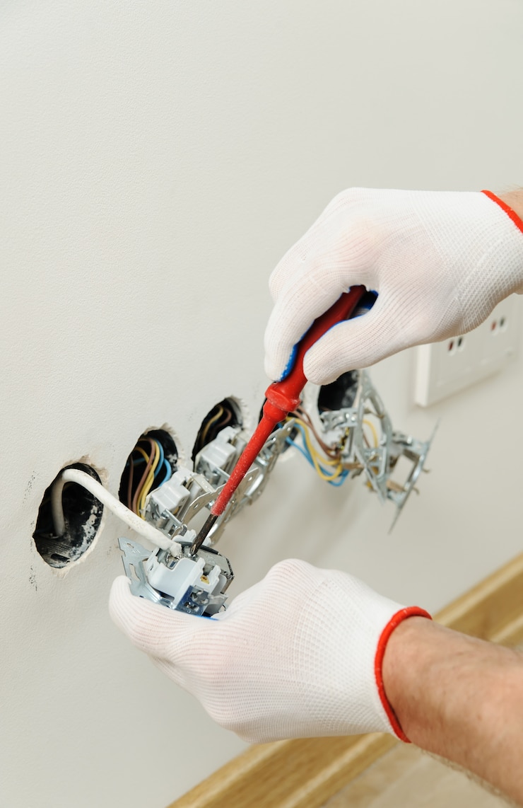 Photo worker installs a tv wall socket