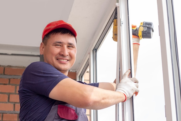 worker installs windows master sverdit frame to attach to the base repair in highrise building