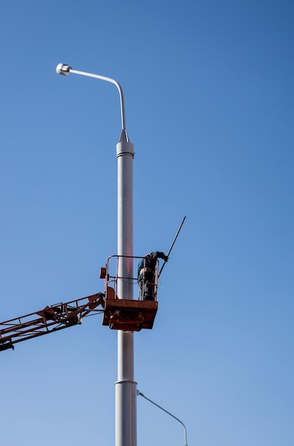 Worker is busy painting a pole