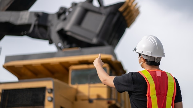 Worker in lignite or coal mining with the truck transporting coal.