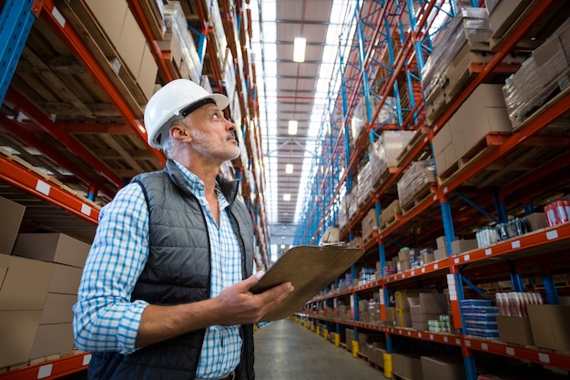 Worker looking up in warehouse