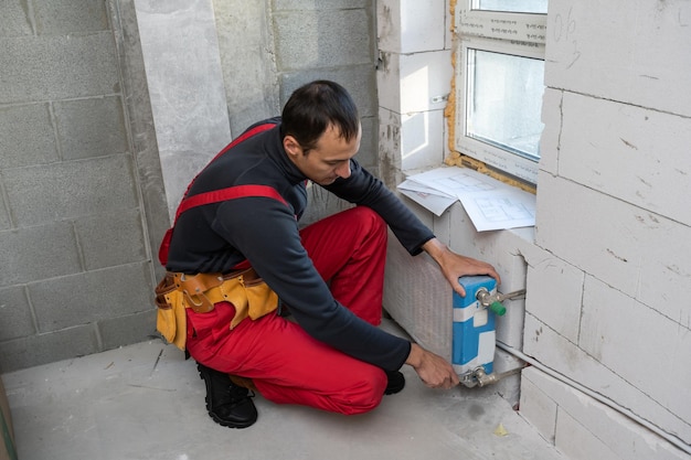 worker makes repairs to the heating battery.