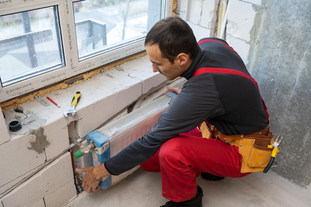 worker makes repairs to the heating battery.