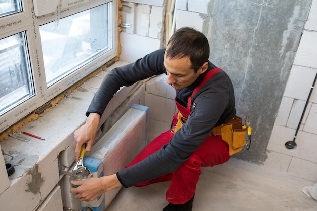 Photo worker makes repairs to the heating battery.