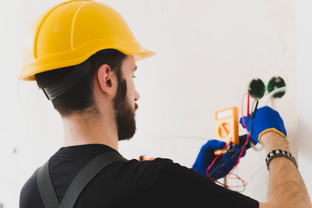 Worker making measures in wires