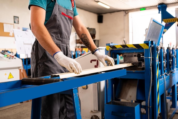 Worker man at factory measures works metal production industrial