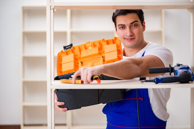 Worker man repairing assembling bookshelf