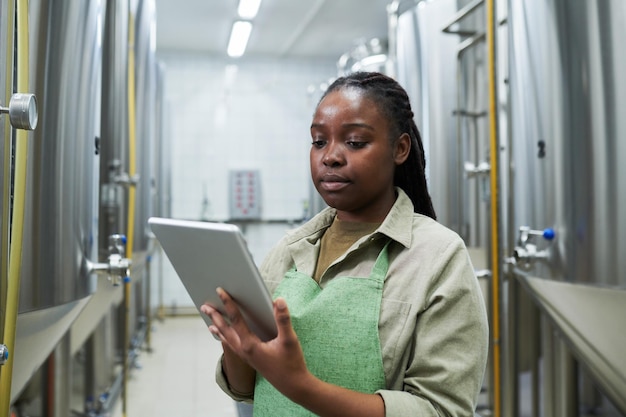 Worker managing fermentation process