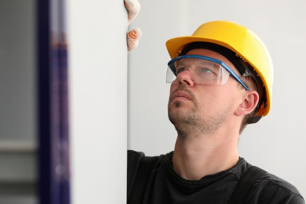 Worker measuring wall size