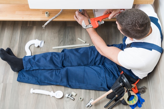 Worker mounting sink in bathroom