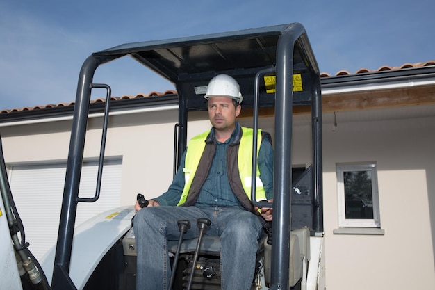 Worker operating a crane at a construction site