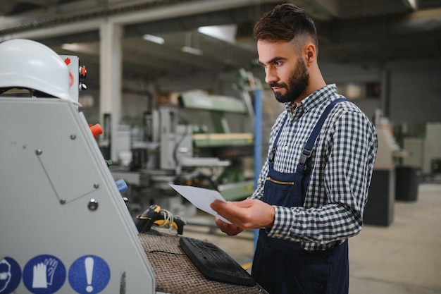 Worker operating machine in factory