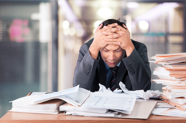 Worker overwhelmed executive working in the office