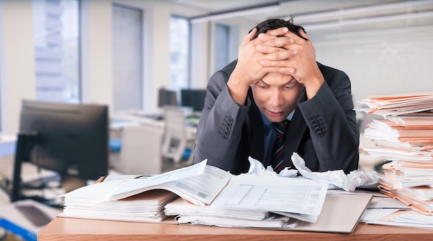 Worker overwhelmed executive working in the office