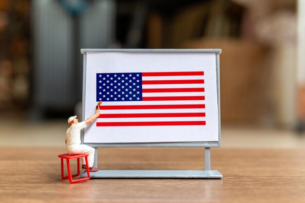 Worker paint on a billboard celebration of the Fourth of July and Independence Day