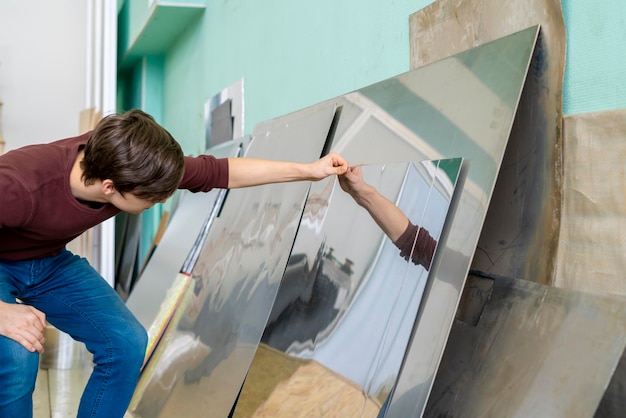 worker pick metal sheet on an industrial factory b