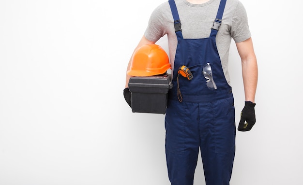 worker in professional uniform with toolbox in hand