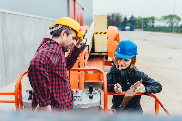 Worker receiving instruction about Straight Boom Lift