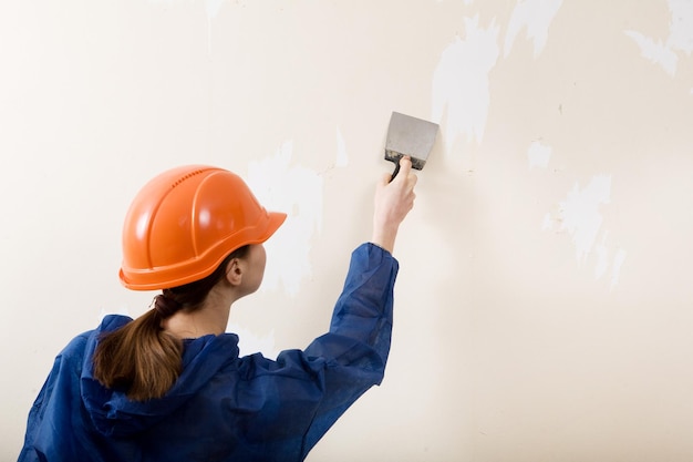 Worker removes old wallpaper