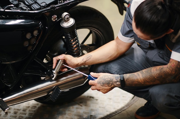 Photo worker repairing motorcycle