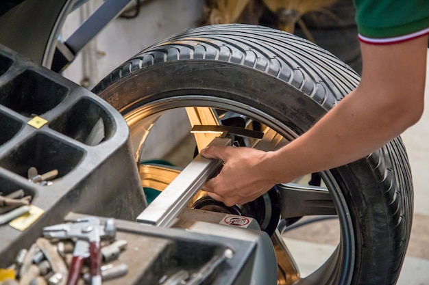 Worker repairs a car in a car repair center