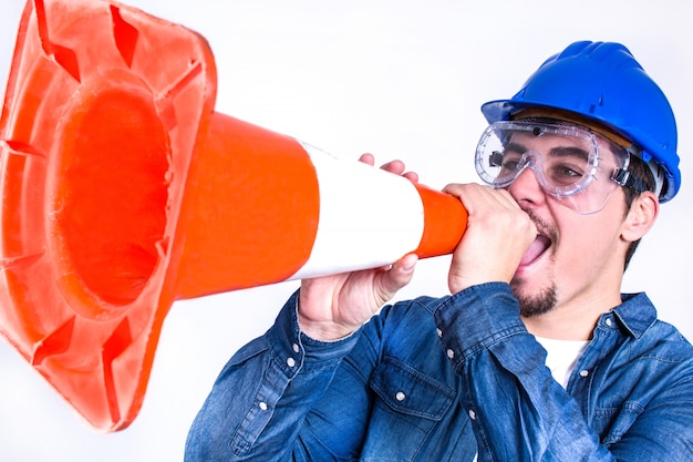 Worker shouting with a cone work isolated