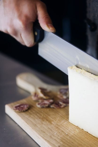 Worker slicing the cheese