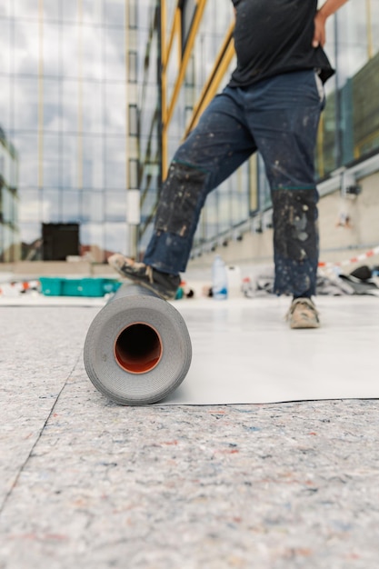 Foto operaio specializzato nel montaggio di membrane in pvc tpo in fase di installazione di un sistema resistente all'acqua