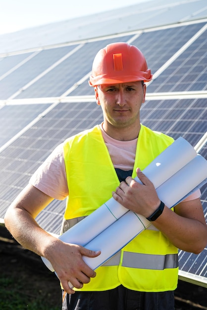 Worker stands with the project near solar panels